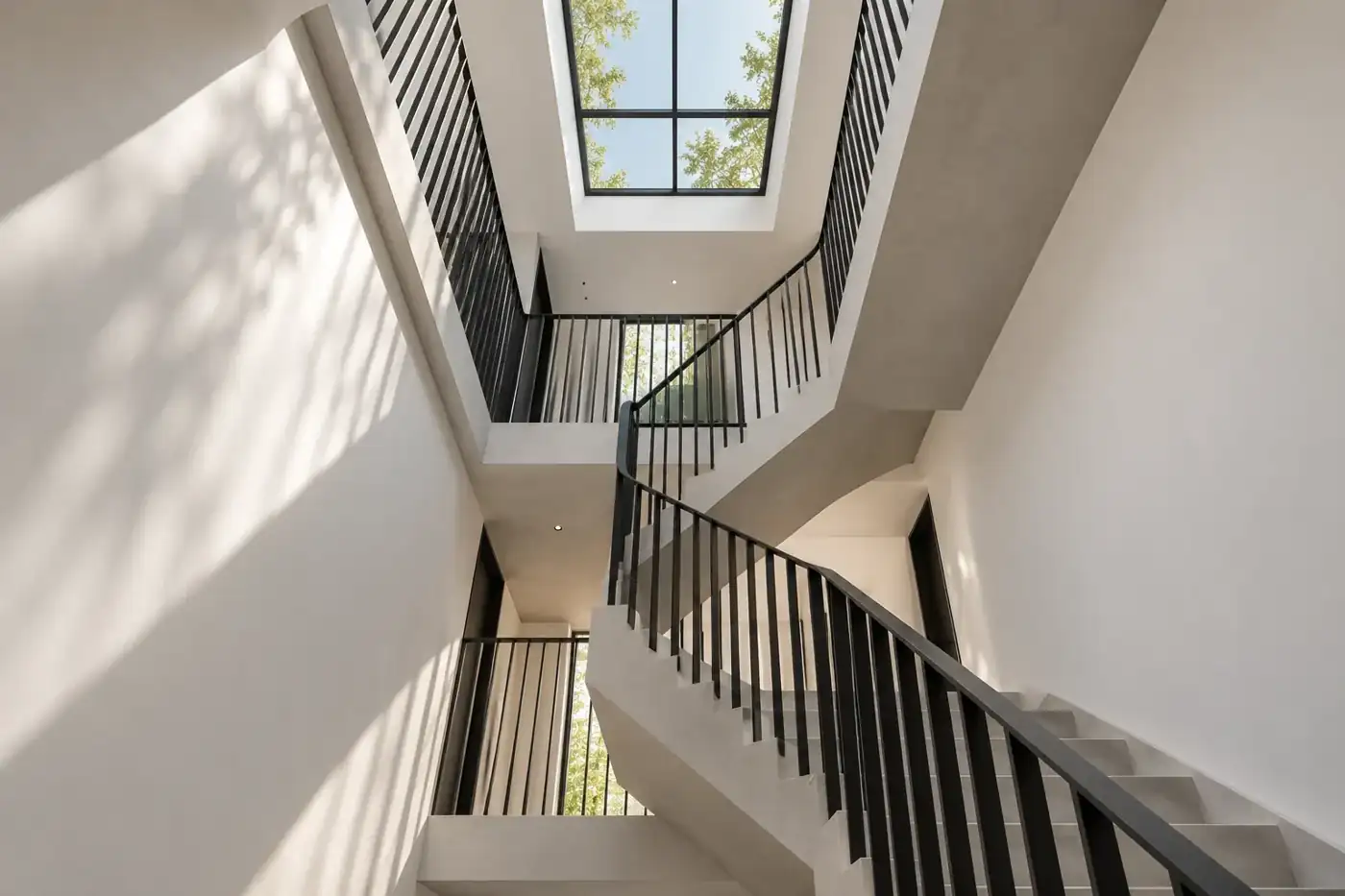 Daylight drawn through the central stair — MAISON NOIRE conceptual visualization